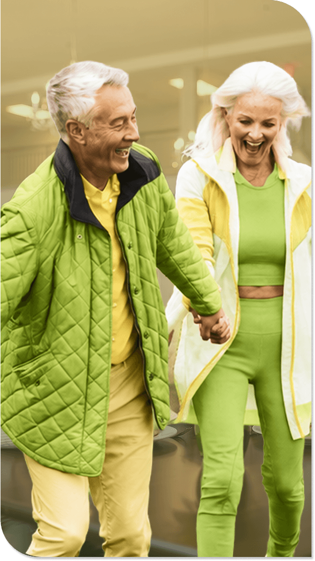 Active Elderly Couple Walking Hand in Hand Outdoors at an Independent Living Facility Active Elderly Couple Walking Hand in Hand Outdoors at an Independent Living Facility