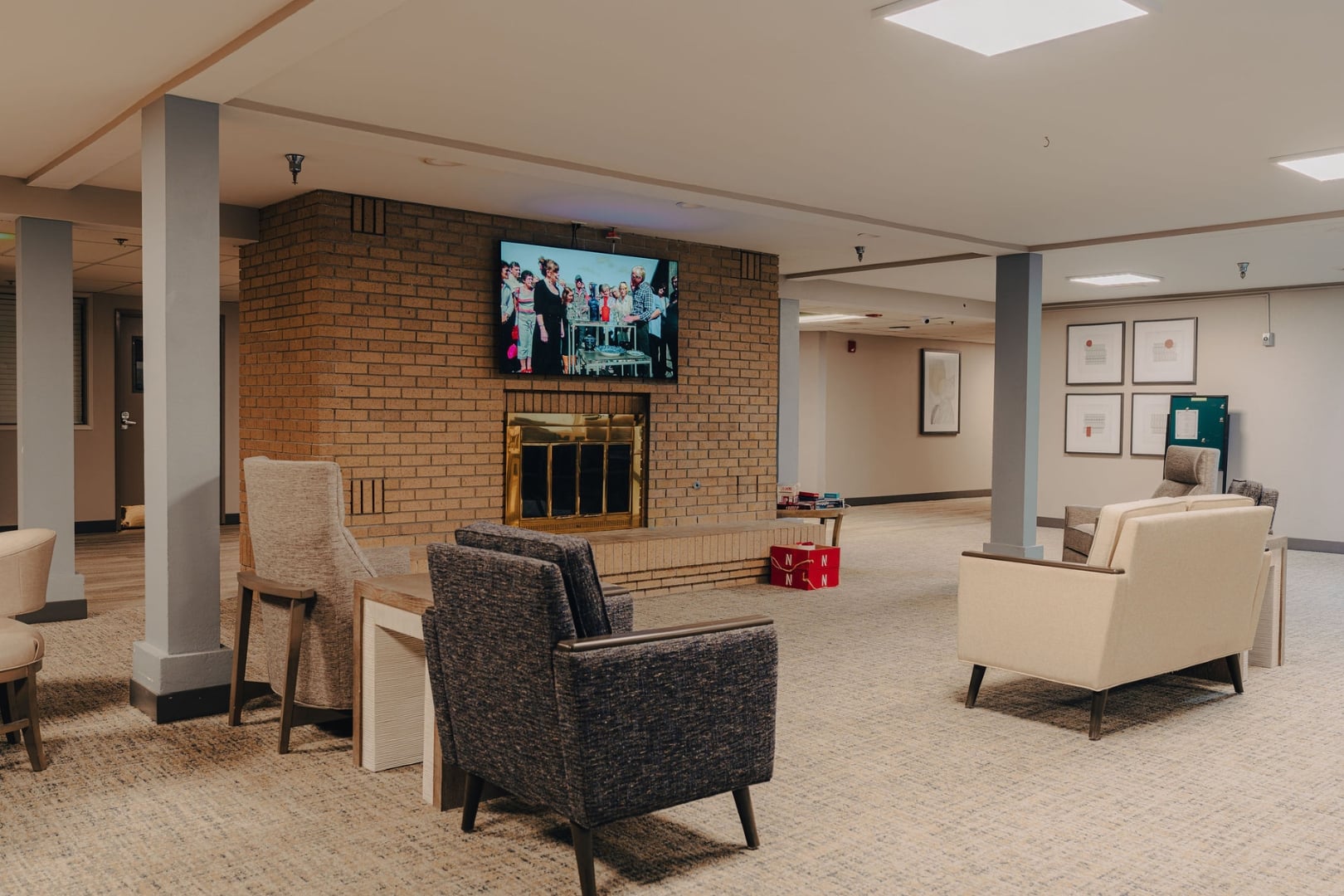 Spacious Common Room With Brick Fireplace and Lounge Seating at Independent Living