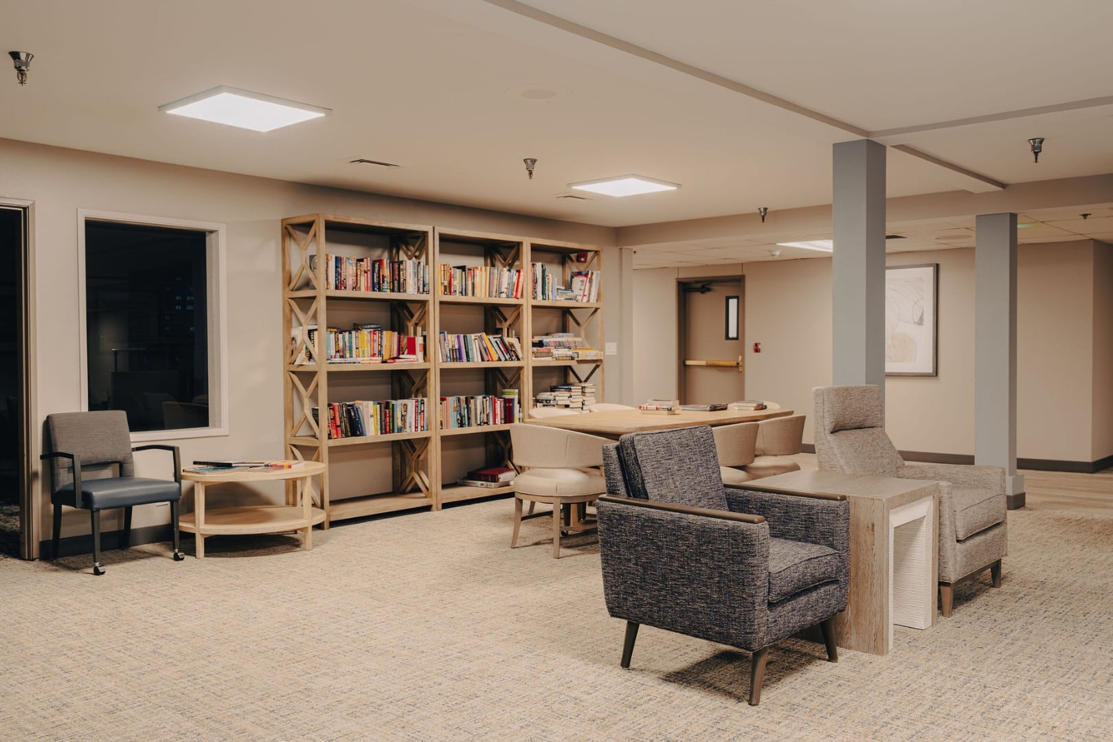 Resident Library With Bookshelves and Reading Chairs at Independent Living Community