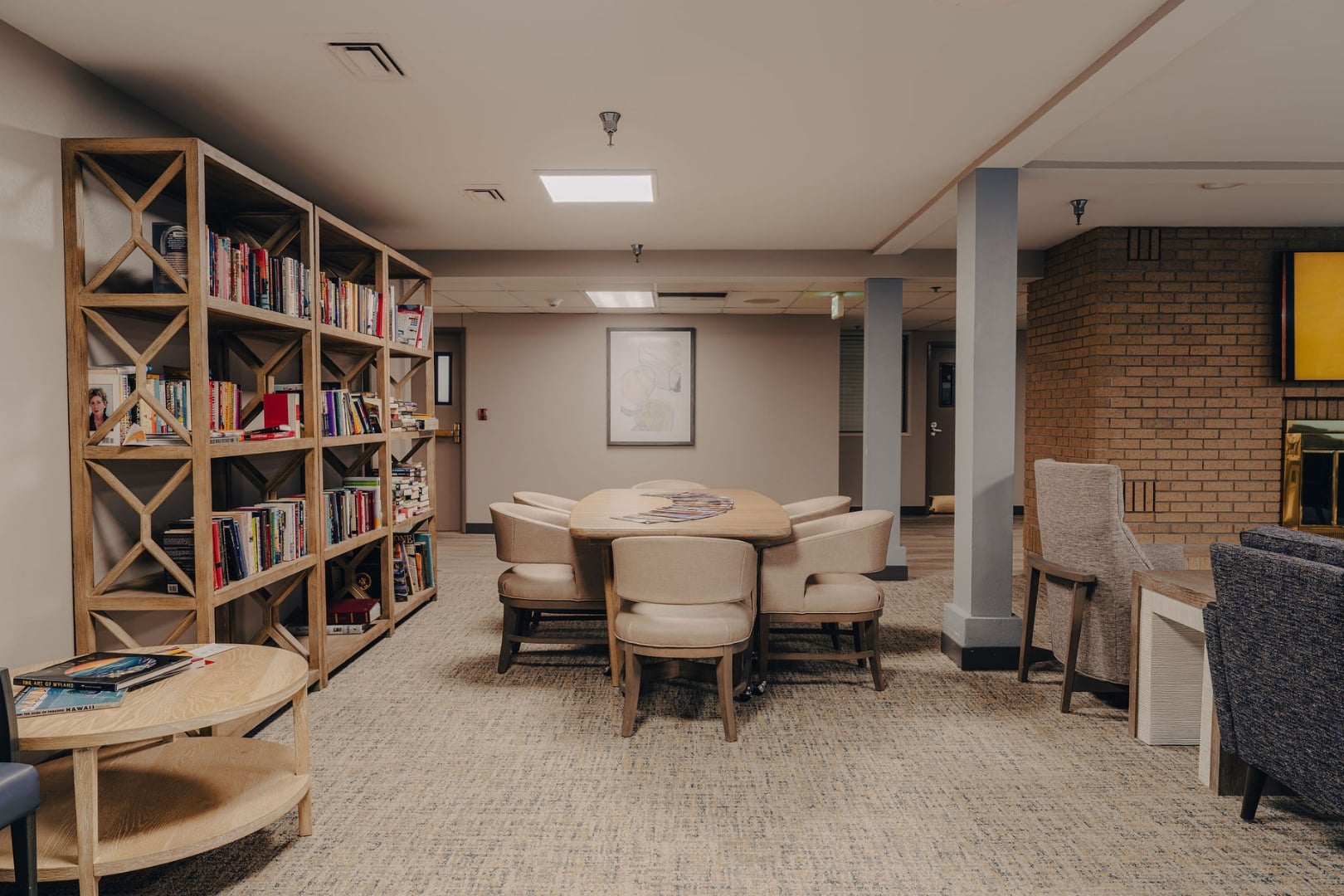 Library Lounge With Bookshelves and Group Seating at Independent Living