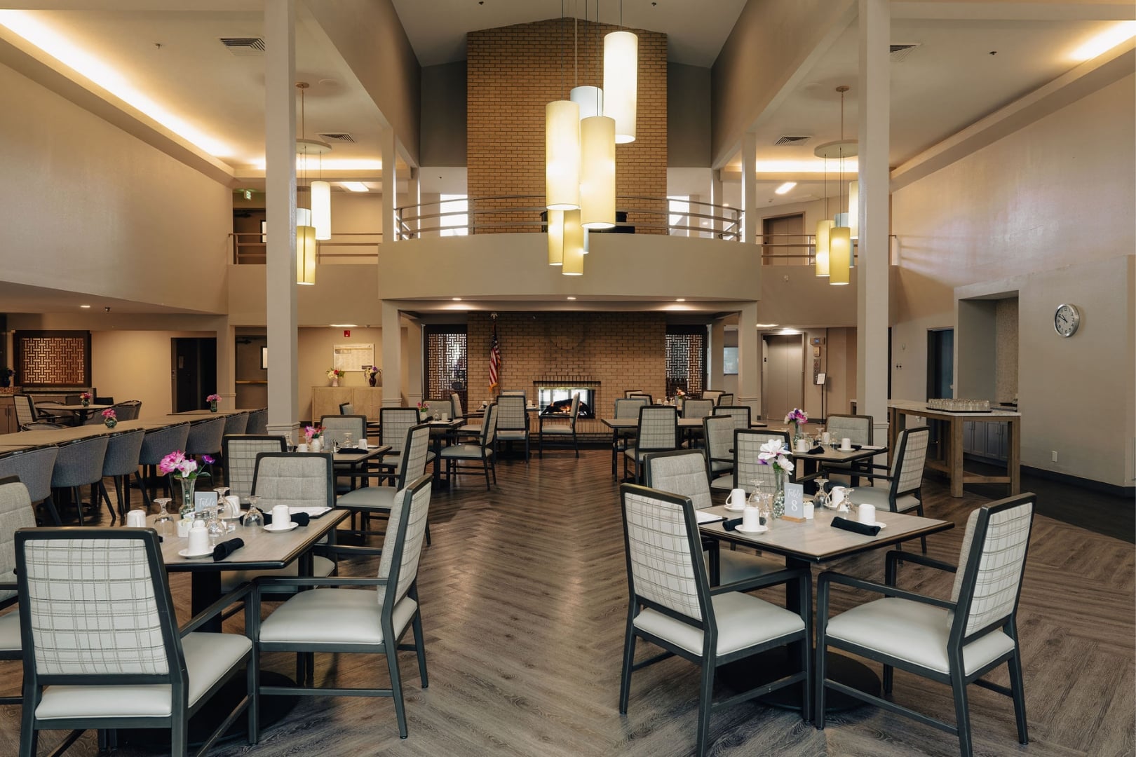 Spacious Dining Room With Fireplace and High Ceilings at Independent Living