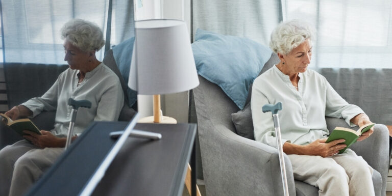 Elderly Woman Reading Quietly Alone at Independent Living Facility