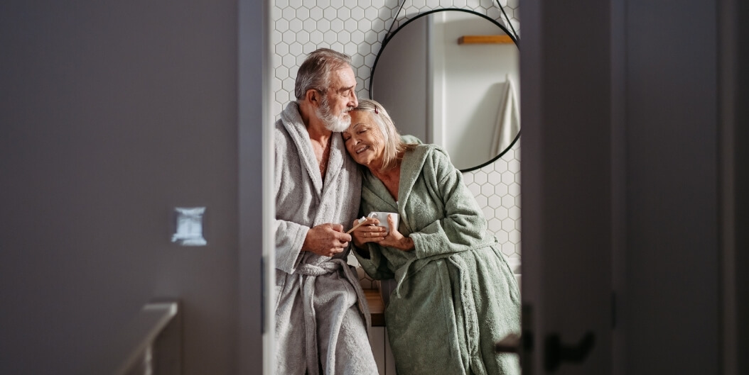 Elderly Couple Sharing Quiet Moment in Independent Living Facility Bathroom
